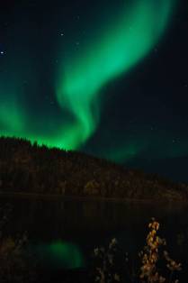 As cores da Aurora reflerem no Yukon River, em Dawson City, no noroeste do Canadá